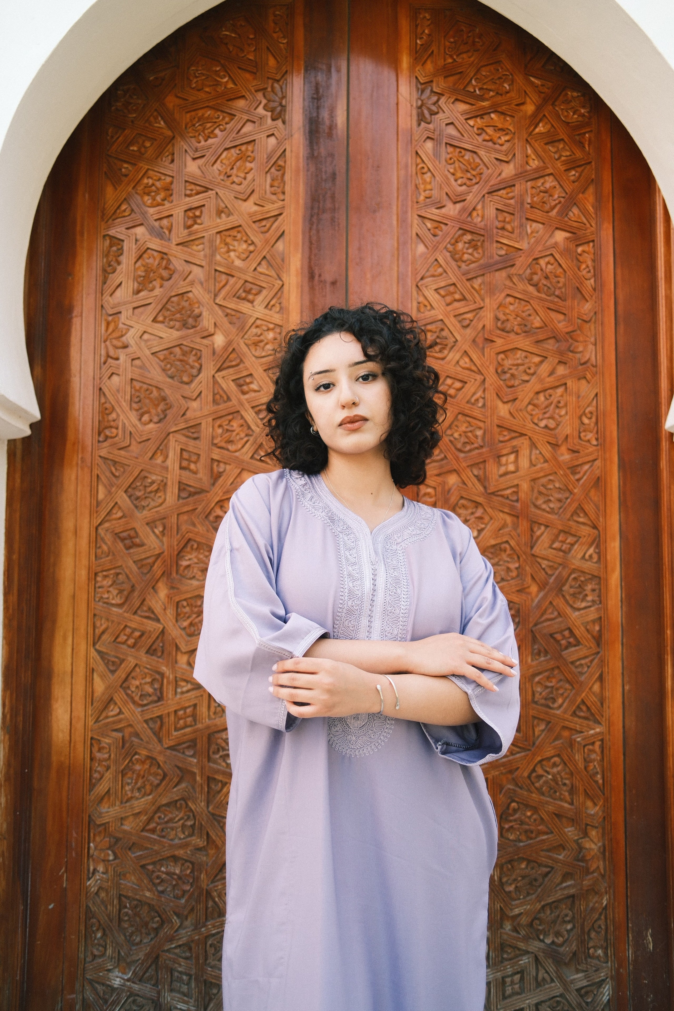 The Amethyst Gandora against a carved Moroccan doorway